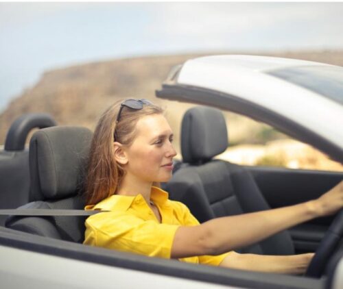 young girl driving a car