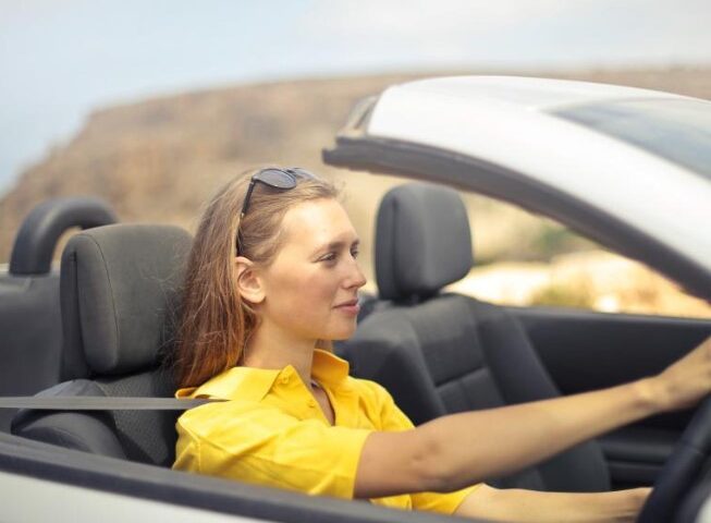 young girl driving a car